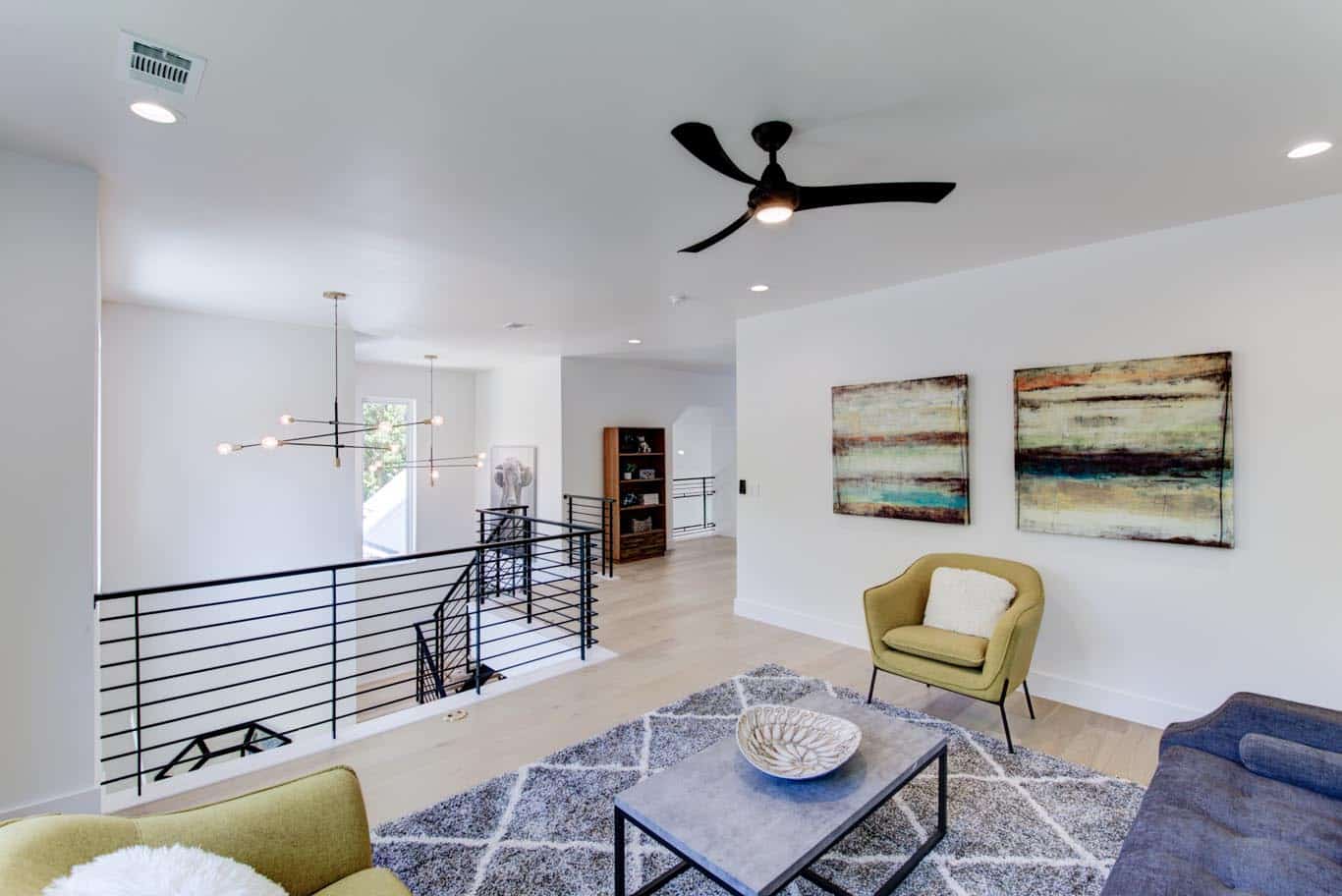 Image of an upstairs nice room with a ceiling fan